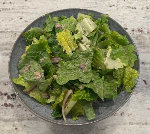 A salad with sardines and onions