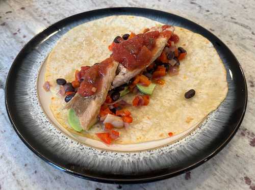 Tacos with mackerel, avocado, pepper, onion, black bean and salsa