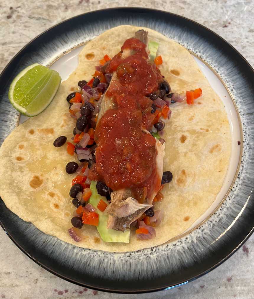 Dress mackerel taco with salsa and lime