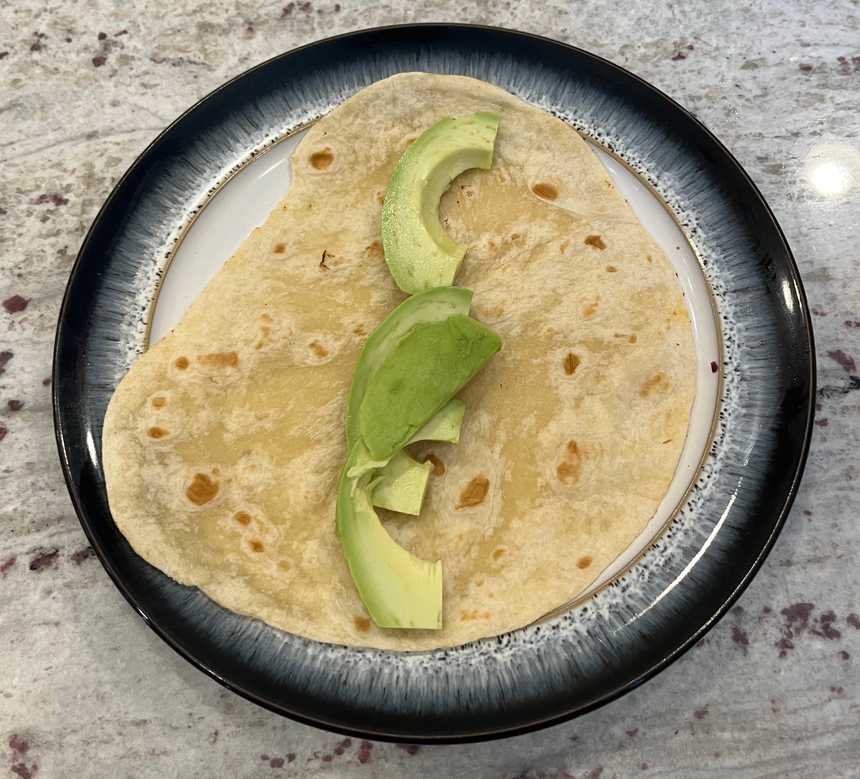 Add avocado to tortilla